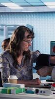 Vertical Old expert measuring the blood pressure and tension with a blood pressure monitor, using professional tools at the medical checkup. Physician does a cardiac reading and measurement. Camera A. video