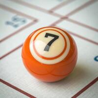 A close up of a billiards ball with the number seven on it photo