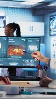 Vertical Male oncology expert reviews radiography results with a patient, discussing lifestyle changes, nutrition and exercise to improve immunity and reduce cancer risk factors. Immune system. Camera A. video