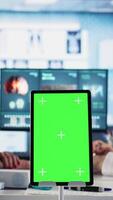 Vertical Experienced physician doing check up routine with patient next to chroma key screen, discussing about medicine and wellness. Old woman using health insurance for consultation with medic. Camera A. video
