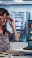 Vertical Healthcare expert man conducting a concussion test with pen light in cabinet, evaluating the woman focus, coordination and pupil reaction after a suspected head trauma. Camera A. video