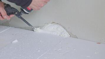 Construction worker removing excess polyurethane foam with oscillating multi-tool video