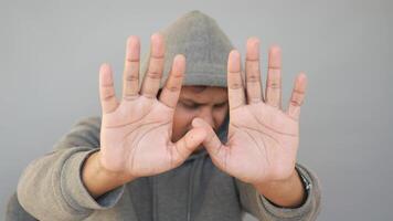 Person gesturing stop with hands in a neutral setting video