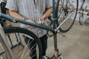 Close up of bicycle mechanic in workshop in the repair process. High quality photo