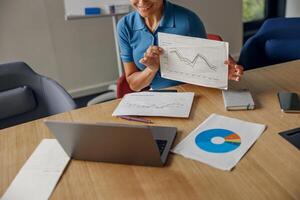 A Business Professional is Effectively Presenting Data Insights During a Meeting Room Session photo