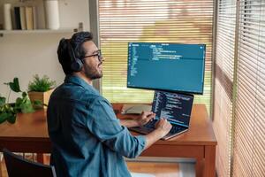 Male freelancer making new project as web designer or programmer on his computer at home office photo