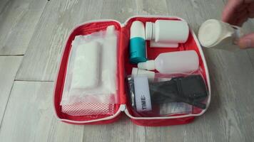 A person holding a toothbrush and toothpaste in a red case video