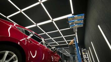 Applying restoration compound to headlight with precision. video