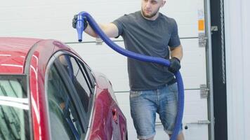 Front windshield with soap foam being cleaned with sponge. video