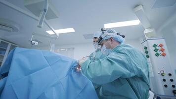 Surgeon uses head-mounted magnifier and precision tools for minimally invasive tonsillectomy. video