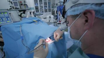 Surgeons performing a complex operation in sterile conditions inside an operating room. video