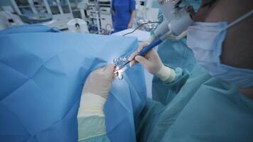 Surgeon performs tonsillectomy using modern cold plasma technology under deep anesthesia in sterile conditions. video