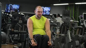 Man with a physical disability performing dumbbell curls during a strength workout. video