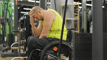 Determined man with a disability performing curls with weights during a workout. video
