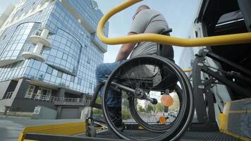 Man in wheelchair entering accessible van via ramp in urban setting. video