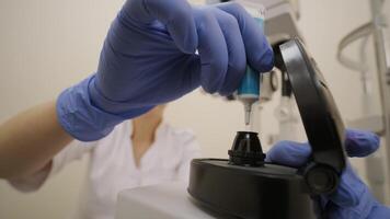 Ophthalmologist surgeon apply the gel to the surface Ophthalmoscopy Lens which is used in ophthalmic for the general diagnosis of eye diseases and specifically for Selective Laser Trabeculoplasty video