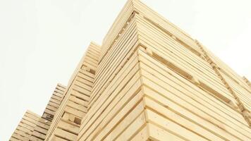 Tall stack of empty wooden vegetable crates in daylight. video