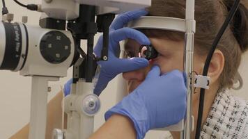 Final stage of laser eye treatment with technician adjusting device. video
