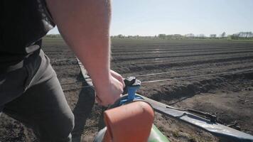 Irrigation system on agricultural land. Water saving drip irrigation system being used in a field. 3 video