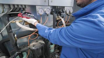 The technician checking power lines of the heat exchanger with current clamps 5 video
