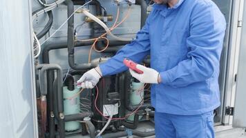 The technician checking power lines of the heat exchanger with current clamps 2 video