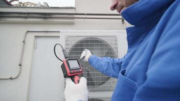 The technician uses a digital camera to check the clogging of the heat exchanger 9 video