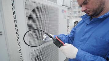 The technician uses a digital camera to check the clogging of the heat exchanger 6 video