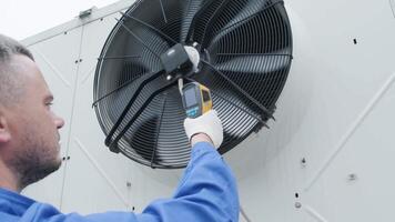 Technician uses a thermal imaging infrared thermometer to check the condensing unit heat exchanger 10 video