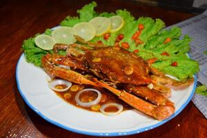 a plate of crab with a slice of lemon on it nobleseed photo