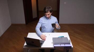 Office worker checking empty wallet at desk with few coins video
