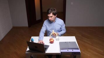 Office worker eating banana at desk during break time video
