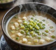 Steaming Creamy Soup with Green Onions and Cheese in a Dark Brown photo