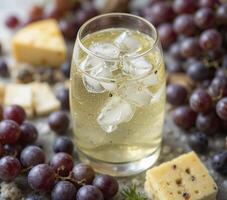 Iced Beverage with Grapes and Cheese on Gray Surface photo
