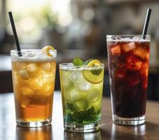Three Iced Drinks Cola, Mint Lemonade, and Iced Tea on Wooden Table photo