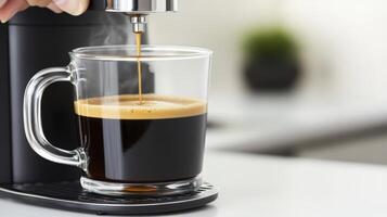 Dark Coffee Pouring into Clear Glass Mug on White Countertop photo