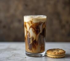Iced Coffee with Creamy Swirl and Cookies on Marble Surface photo
