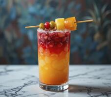 Red And Orange Layered Beverage with Fruit Garnish on Marble photo