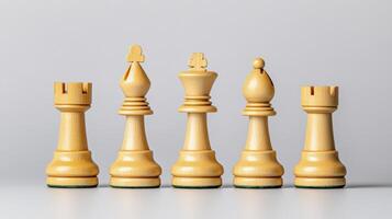 Five Wooden Chess Pieces On Gray Background photo