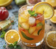 Closeup View of a Refreshing Summer Fruit Cocktail with Ice and Mint photo