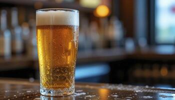 Condensation Covered Glass of Light Amber Beer on a Bar Top photo