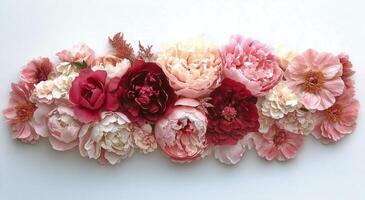 Vibrant Floral Arrangement With Peonies and Roses in Soft Pink and Red Hues Against a Light Background photo