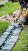 Crafting a Stone Pathway in a Garden During Daylight Hours With Skilled Hands and Precision photo