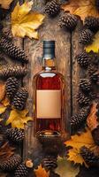 Warm Autumn Atmosphere With Whiskey Bottle and Seasonal Decorations on Wooden Surface photo