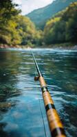 Fishing Rod Rests on the Surface of a Calm River Surrounded by Lush Greenery photo