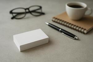 Desk Setup With Blank Business Cards, Notebook, Coffee Cup, and Glasses for Creative Work photo