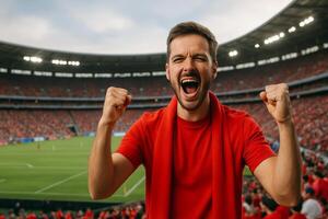 Excited Fan Celebrates During a Soccer Match in a Packed Stadium on a Sunny Afternoon photo