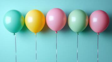 Colorful balloons in pastel shades of green, yellow, and pink are arranged in row against light blue background, creating cheerful and festive atmosphere photo