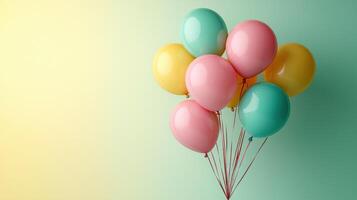Colorful balloons in pastel shades of pink, yellow, and turquoise float against soft gradient background, creating cheerful and festive atmosphere perfect for celebrations photo