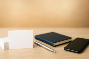 Desk Setting With Stationery, Notebook, Phone, and Blank Cards on Wooden Surface for Creative Work photo