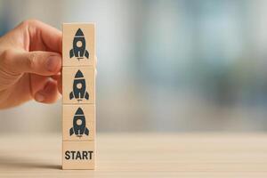 Launching a New Project With Wooden Blocks Featuring Rockets Stacked on a Table photo